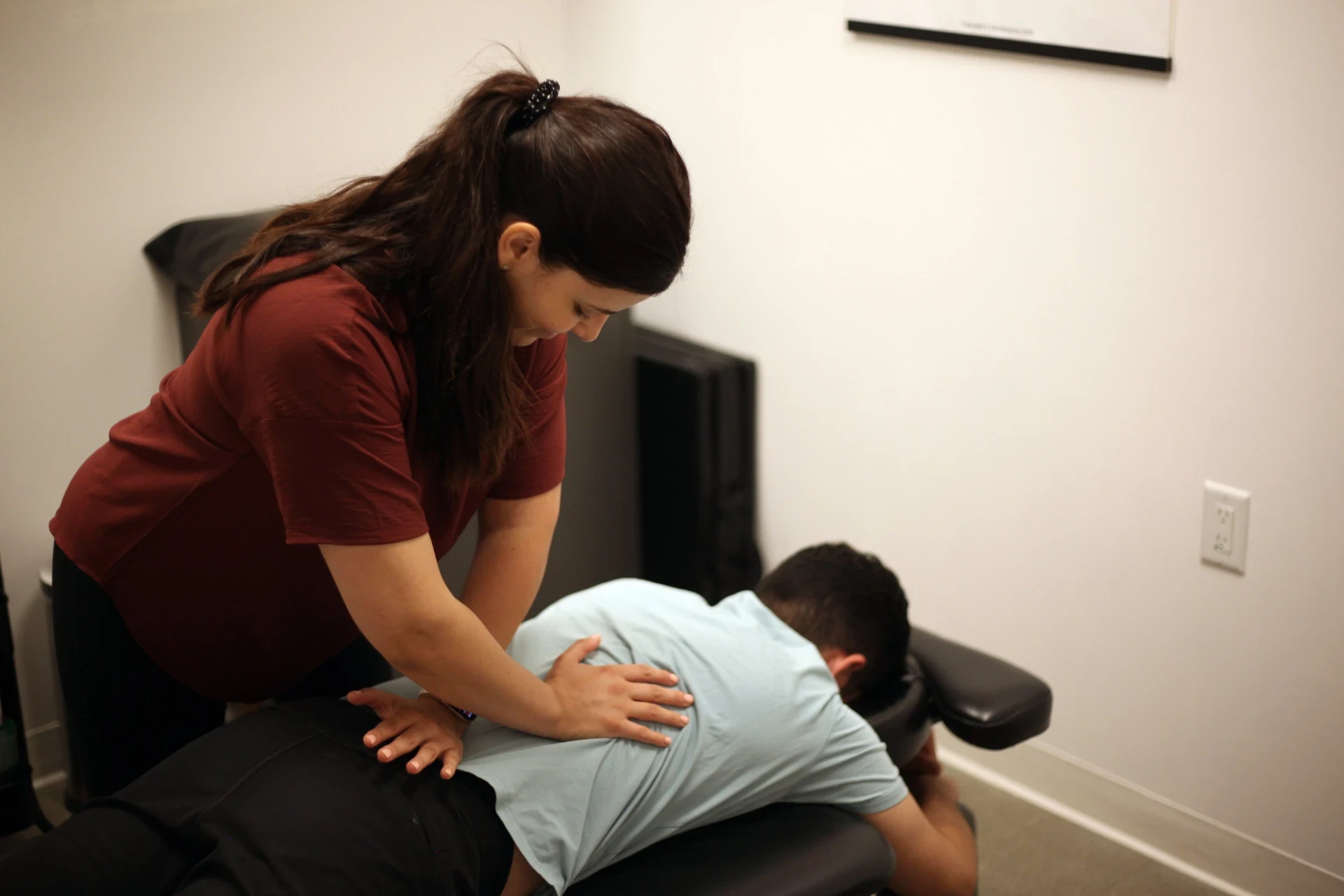 Dr. Natalie providing a prone spinal adjustment during a chiropractic appointment.
