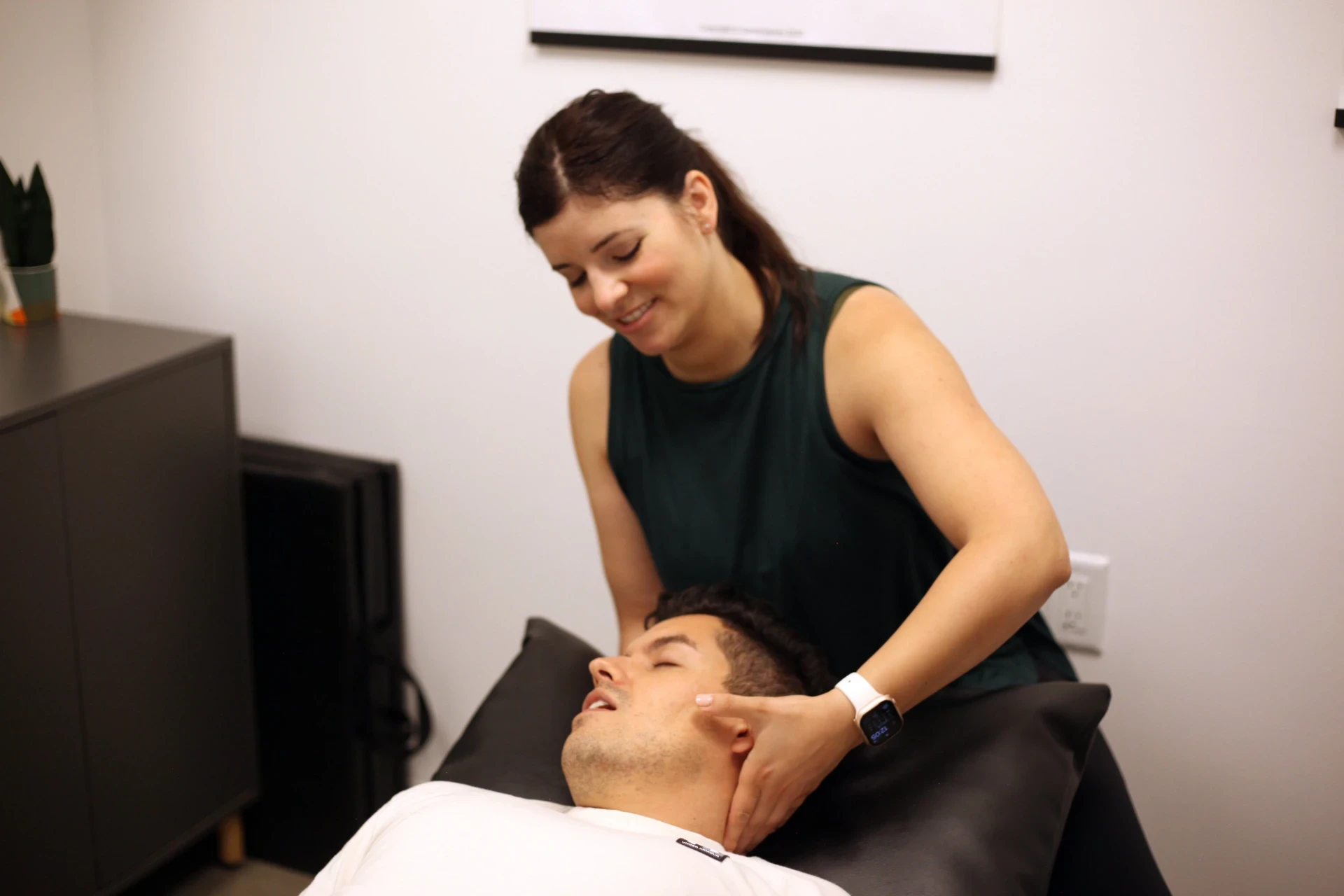 Dr. Natalie providing external jaw and upper-neck care to a patient.